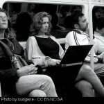 Woman on laptop on subway